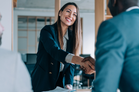 Business woman shaking hands with partners