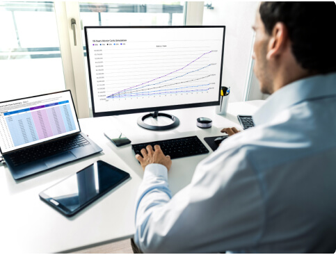 Business man on computer looking at charts for retirement planning