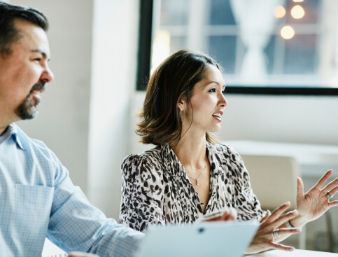 Two professionals in a meeting discussing brand