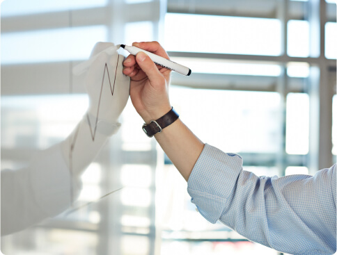 Business man drawing chart on board to demonstrate compliance process