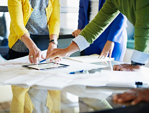 Financial professional showing clients their portfolio on a tablet