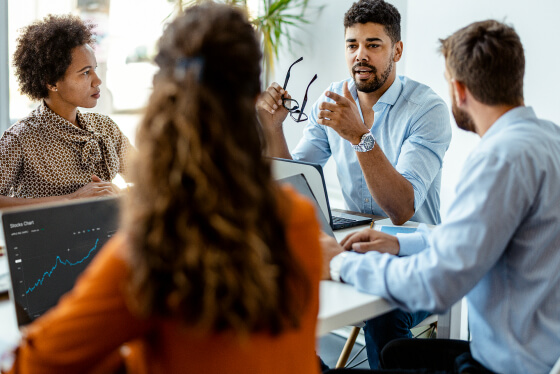 Group of people sitting in a conference room engaging in dialogue