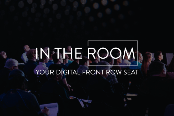 Theater filled with people watching an In The Room presentation