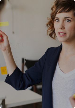 Business woman pointing at whiteboard during a meeting