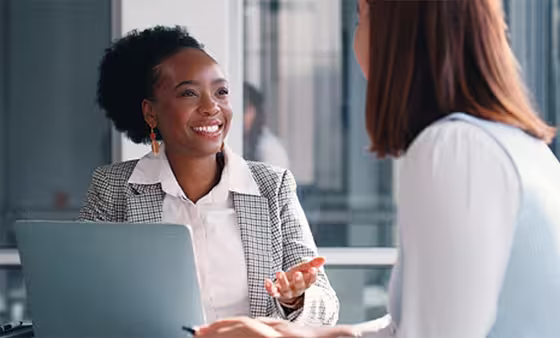 Coworkers meeting at desk